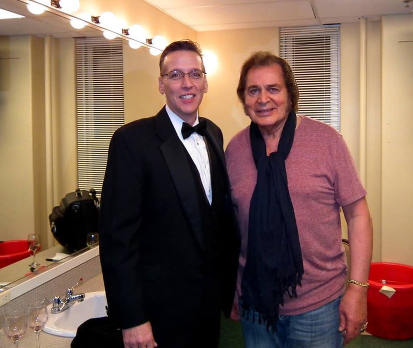 Eric Thompson shares a backstage moment with a fellow entertainer, showing the camaraderie that happens behind the scenes between performers.