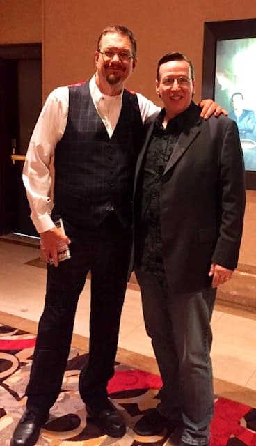 Eric Thompson poses with a fan backstage, both men beaming with the kind of warm camaraderie that speaks to Eric's reputation as a genuinely personable entertainer who connects with audiences on and off stage.