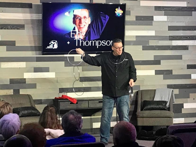 Eric Thompson captivates his audience with an impressive linking rings routine, demonstrating the classic magic that has made him a favorite at venues across the country for decades.