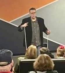 Eric Thompson commands the stage with his signature blend of comedy and magic, working his charm on an appreciative audience from an elevated platform.