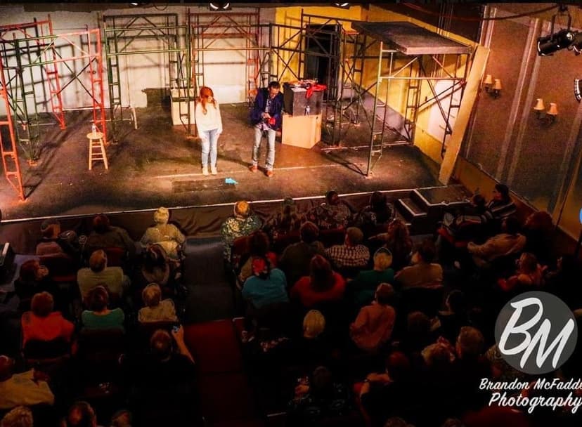 Eric Thompson captivates a packed theater audience from the stage, with the intimate venue creating perfect conditions for his signature blend of comedy and magic to work its charm on the crowd below.