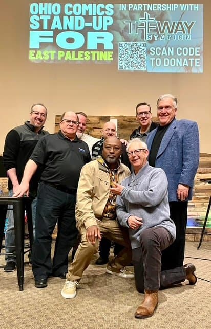 Eric Thompson poses with fellow comedians and supporters at a charity fundraiser for East Palestine, showing how laughter can bring people together for a great cause.