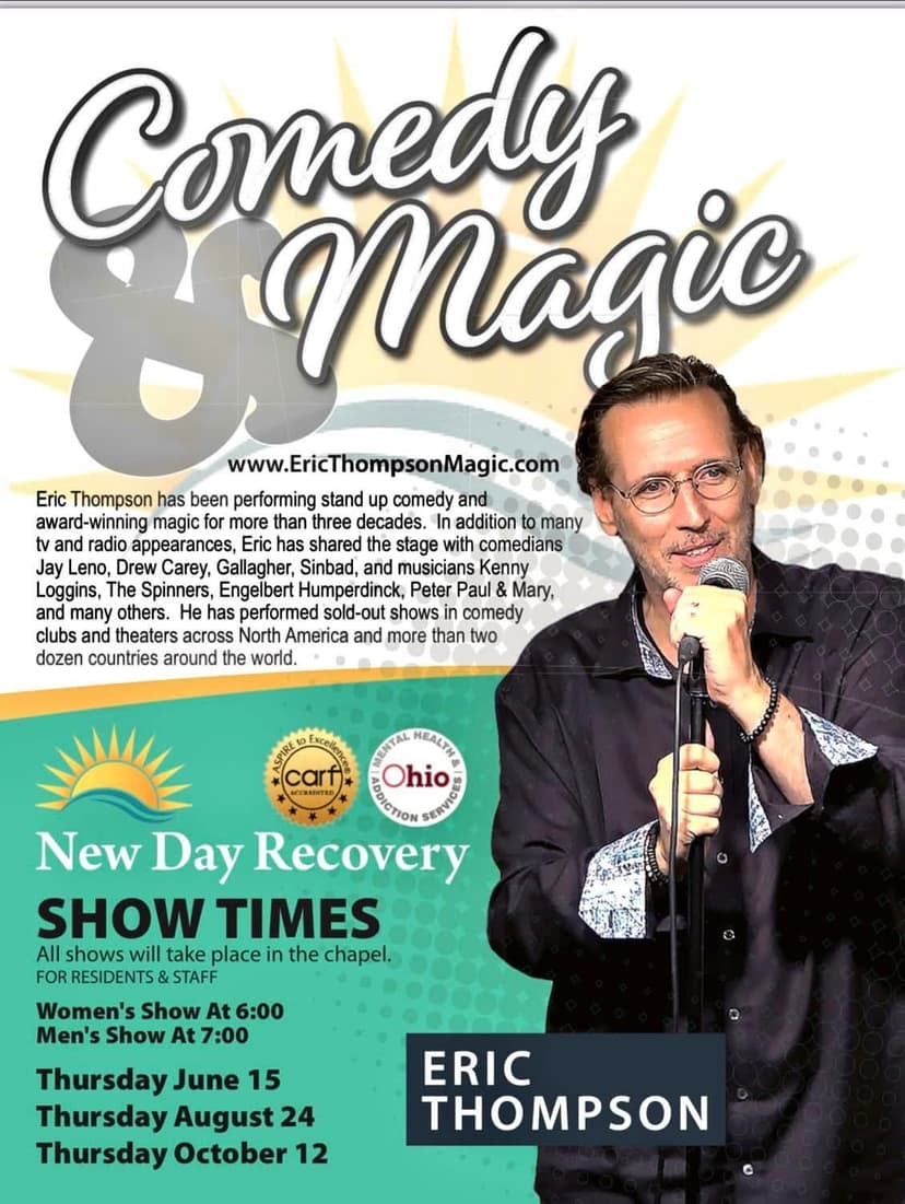 Eric Thompson commands the stage with microphone in hand, ready to deliver his signature blend of comedy and magic to an eager audience.