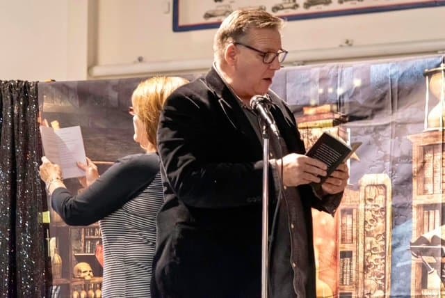 Eric Thompson captivates the audience with his signature blend of comedy and storytelling, book in hand as he delivers another memorable performance that has crowds laughing across the country.