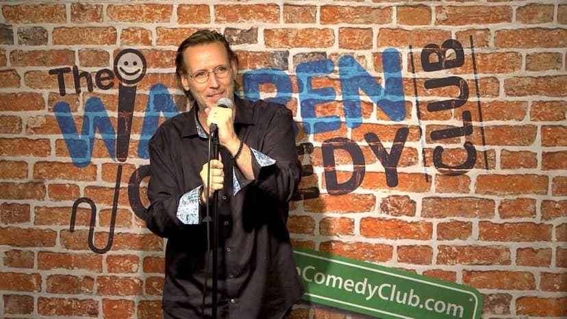 Eric Thompson takes the stage at The Warren Comedy Club, microphone in hand and ready to deliver his signature blend of comedy and magic to another eager audience.
