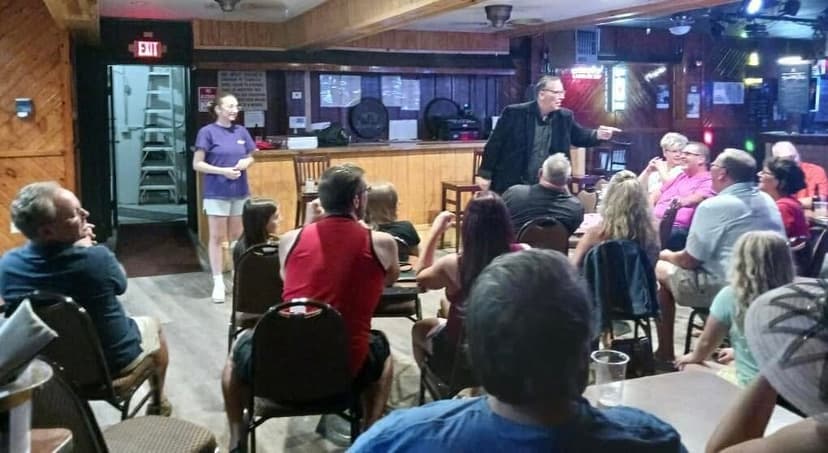 Eric Thompson captivates a packed restaurant crowd during an intimate comedy performance, working his magic with the audience seated just feet away from the action.