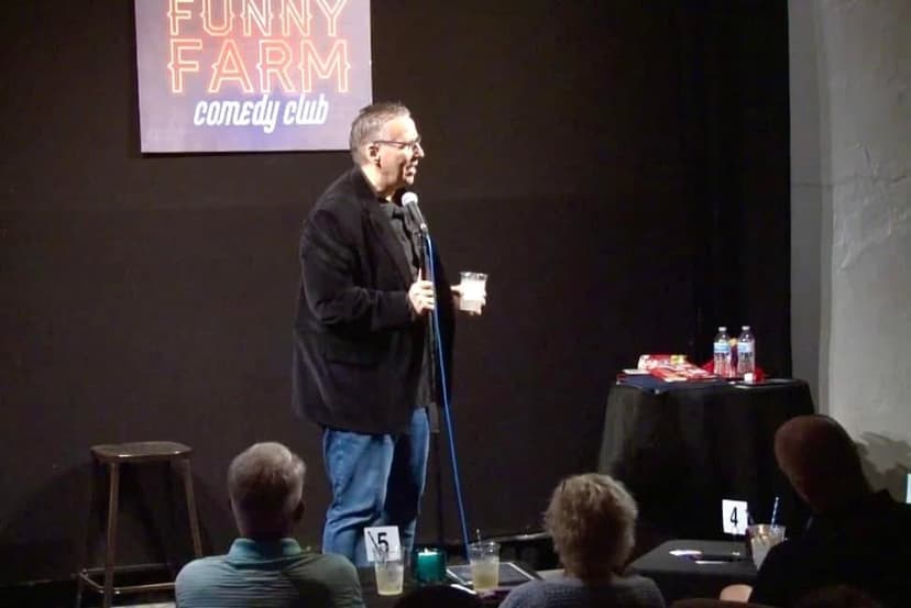 Eric Thompson commands the stage at the Funny Farm Comedy Club, drink in hand as he delivers his signature blend of humor to an intimate audience of comedy lovers.