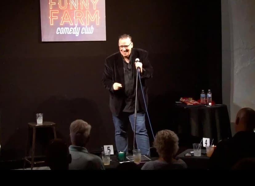 Eric Thompson commands the stage at the Funny Farm Comedy Club, delivering his signature blend of comedy and charm to an intimate audience of delighted patrons.