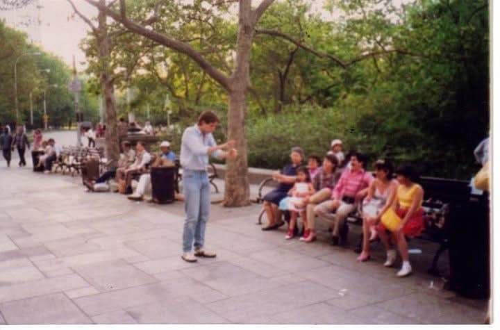 Eric Thompson captivates a park bench audience with his signature blend of comedy and magic, turning an ordinary day outdoors into an impromptu street performance that has everyone leaning in for more.
