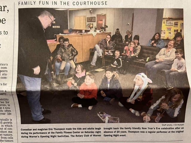 Eric Thompson captivates a roomful of families and kids during what appears to be a special courthouse event, bringing his signature blend of comedy and magic to an appreciative audience of all ages.
