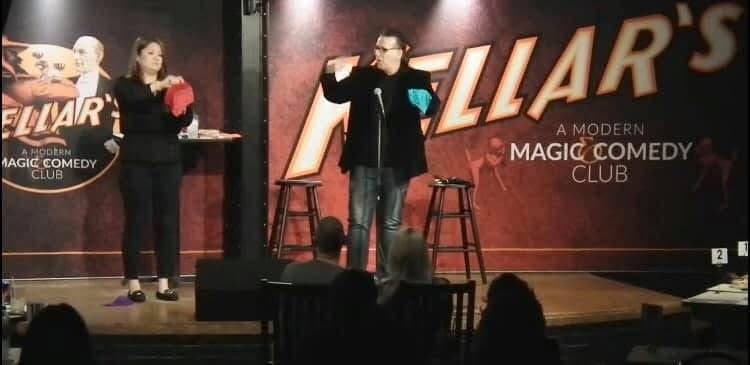 Eric Thompson commands the stage at Heliar's Modern Magic Comedy Club, delivering his signature blend of comedy and magic to an engaged audience in this intimate venue setting.
