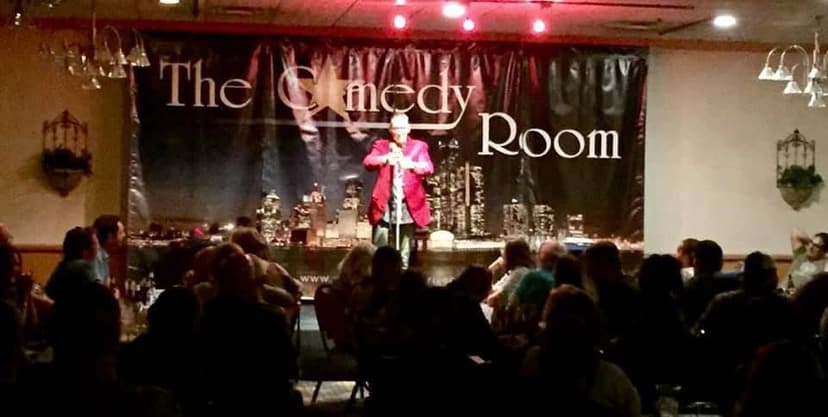Eric Thompson commands the stage at The Comedy Room, delivering his signature blend of humor to a packed house of eager audience members.
