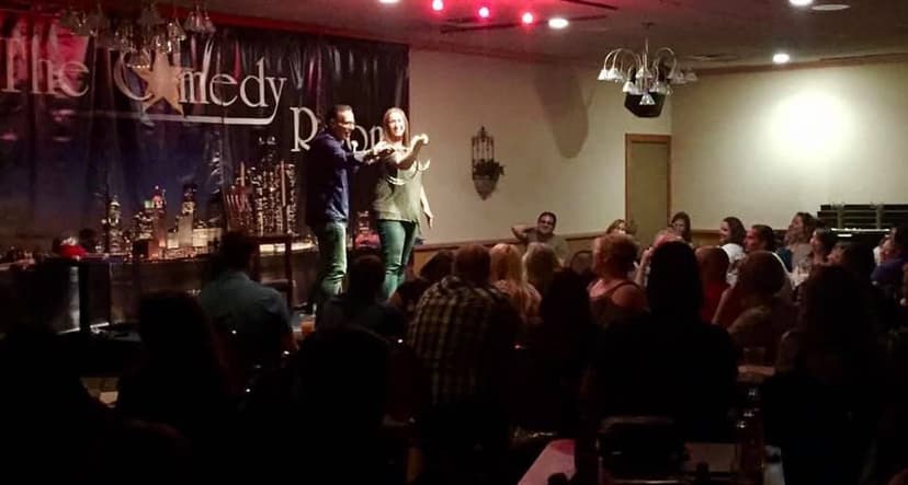 Eric Thompson commands the stage at a packed comedy club, working his magic with the intimate crowd as audience members lean in for every laugh and gasp.